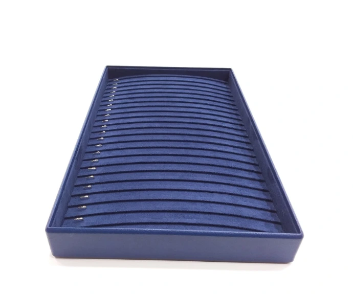 Elegant bracelet tray with blue rexine sides and a soft blue suede interior, featuring silver hooks to display and organize bracelets.